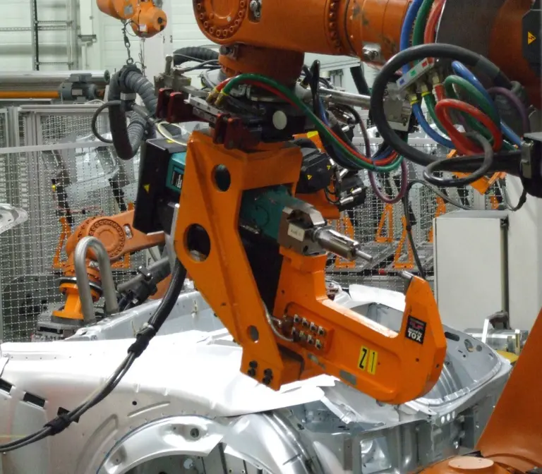 Industrial robot working on a car body.