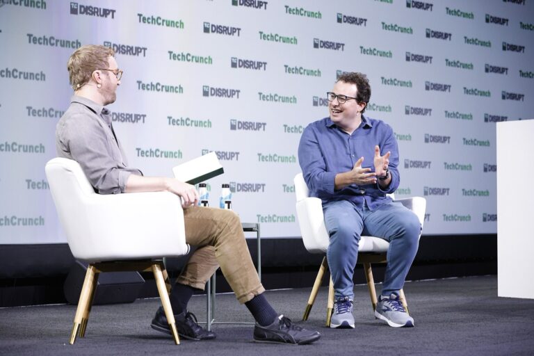Dario Amodei, seated right, at TechCrunch Disrupt, 20 September 2023. Archive; not an IPO ceremony.