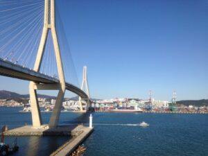 Busan Harbor Bridge and the container terminal, South Korea, 20 October 2018. Archive trade context; not the 2026 GDP briefing.