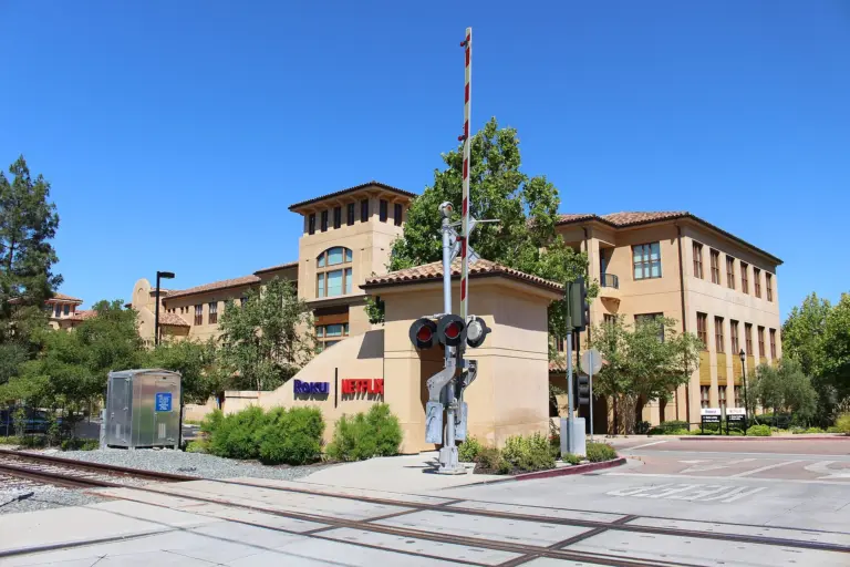 Office building at 100 Winchester Circle, formerly occupied by Netflix, with landscaped grounds.