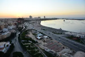 Tripoli harbour and waterfront buildings viewed from above at sunset.
